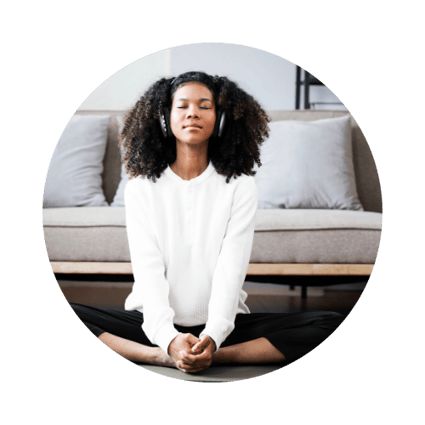 Woman meditating in a white sweater representing spiritual healing at Eclectic Lyfe LLC